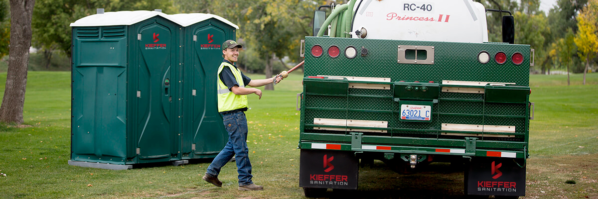 Photo of Kieffer Sanitation worker about to pump out two portable toilets.