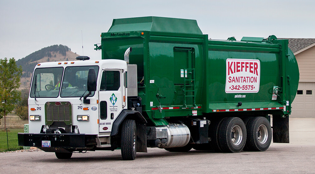 Photo of a Kieffer Sanitation truck leaving a residential home.