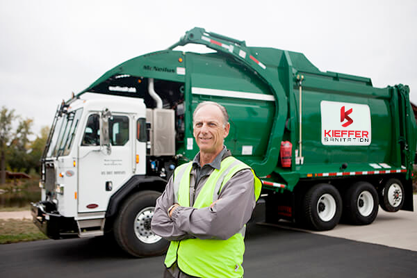 Photo of Kieffer Sanitation worker standing by truck.
