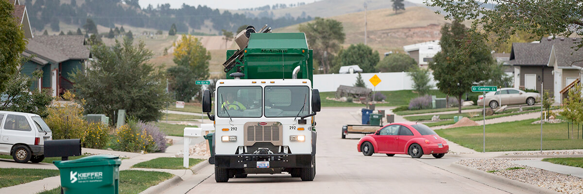 Photo of Kieffer Sanitation truck in residential neighborhood.